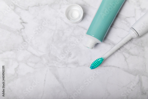 Toothbrush and tube of toothpaste on marble background with copy space. Flat lay. Oral hygiene. Oral Care Kit. Dentist concept. Place for text. Place to copy.