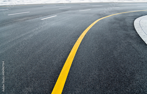 Asphalt road with white stripes and yellow lines © xy
