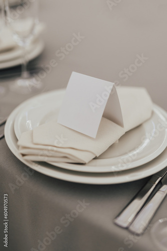 Obraz na płótnie Table setting with white plate, glasses and cutlery on table. Table served for wedding banquet in restaurant.
w salonie