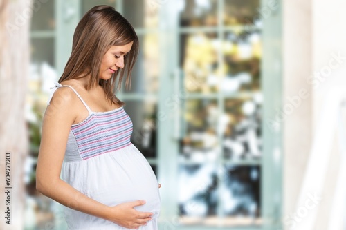 Free Download Happy pregnant young woman at home - GFXLoad