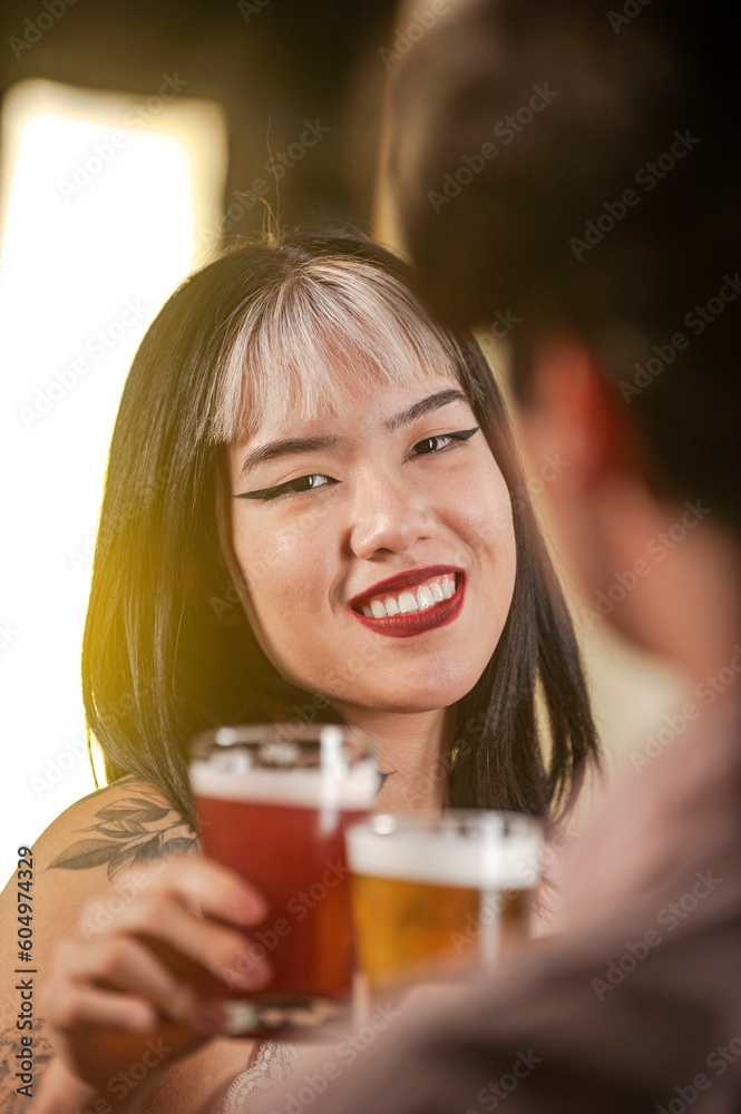 Happy couple toasting with beer at pub restaurant. Happy couple toasting with beer at pub restaurant.
