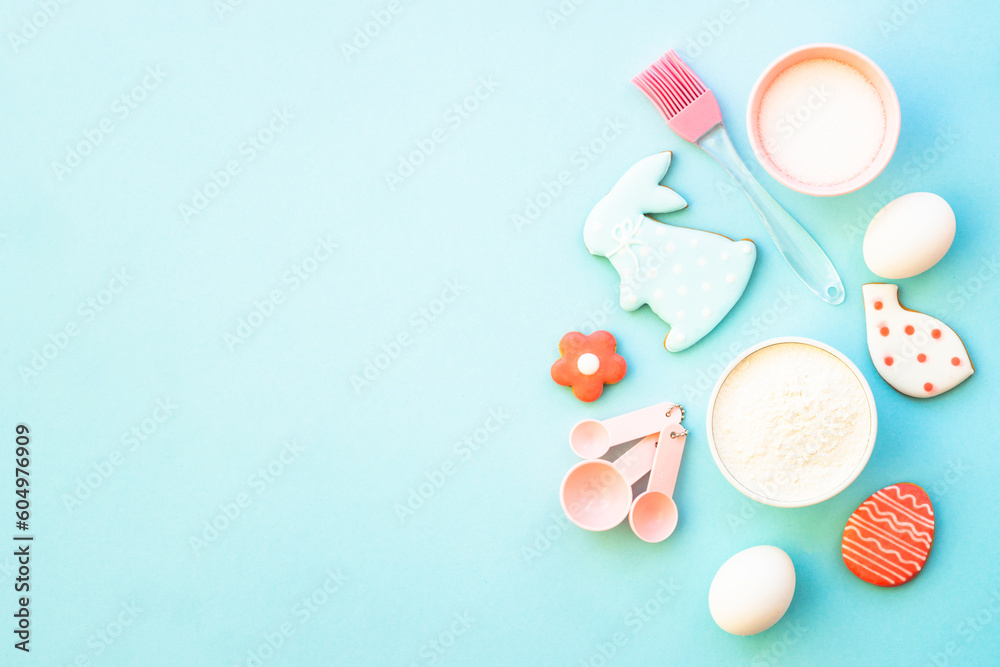 Easter baking background on blue. Flour, edds, sugar and gingerbread cookies. Top view with copy space. Easter baking background on blue. Flour, edds, sugar and gingerbread cookies. Top view with copy space.