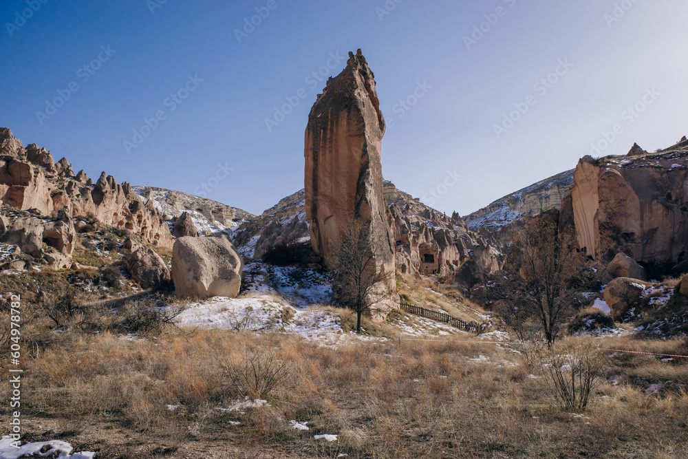 Fototapeta premium Cave town and rock formations in Zelve Valley, Cappadocia, Turkey - feb 2023