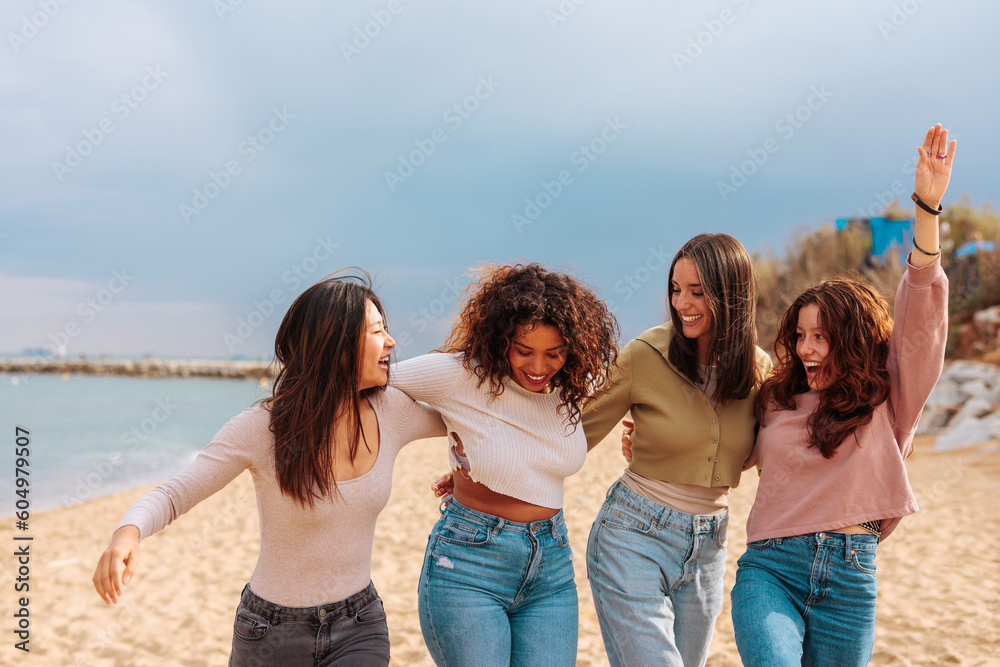 Four diverse best girl friends jumping together on beach. Four diverse best girl friends jumping together on beach.