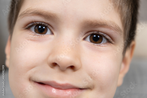 Slika na platnu Portrait of a handsome brown-eyed 5-year-old boy looking at the camera and smili