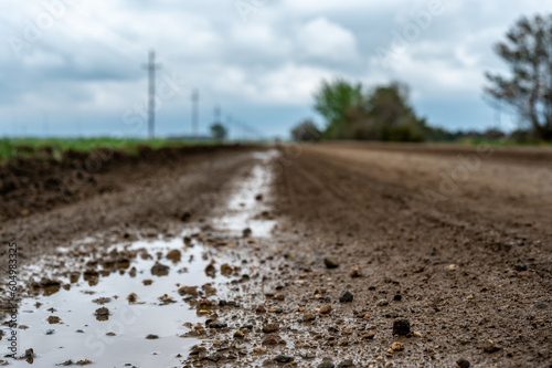 low angle view of a mud on a gravel road from a recent rainstorm.