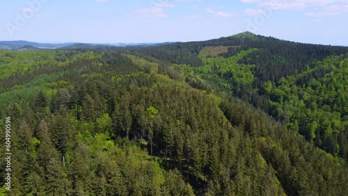 German Forest in the Mosel region close to the Nurburgring Nordschleife. Cars driving on curvy roads through green woods in the sunny summer day in the hills  photo