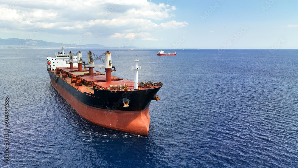 Aerial drone photo of huge bulk carrier tanker anchored in deep blue Aegean sea