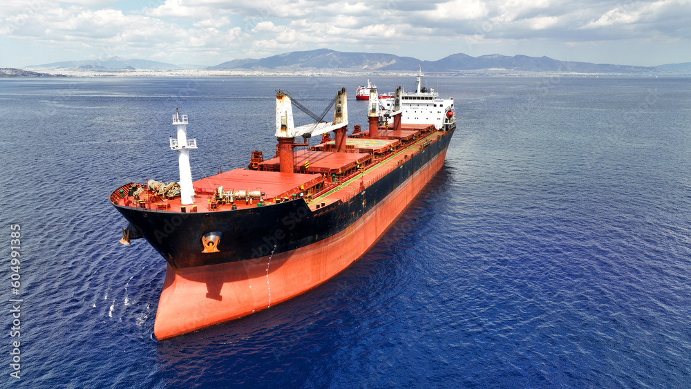 Aerial drone photo of huge industrial bulk carrier tanker anchored in deep blue Aegean sea