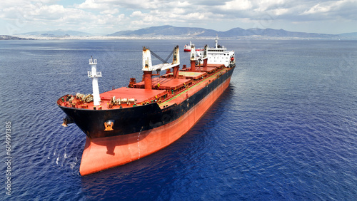 Aerial drone photo of huge industrial bulk carrier tanker anchored in deep blue Aegean sea photo