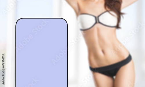 Beautiful female body and blank screen phone photo