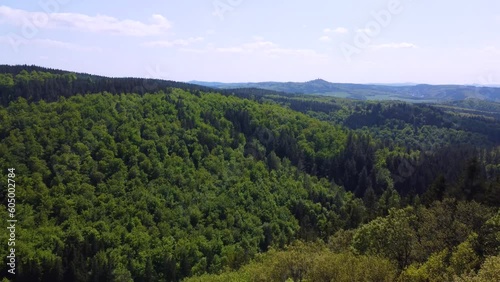 German Forest in the Mosel region close to the Nurburgring Nordschleife. Cars driving on curvy roads through green woods in the sunny summer day in the hills  photo