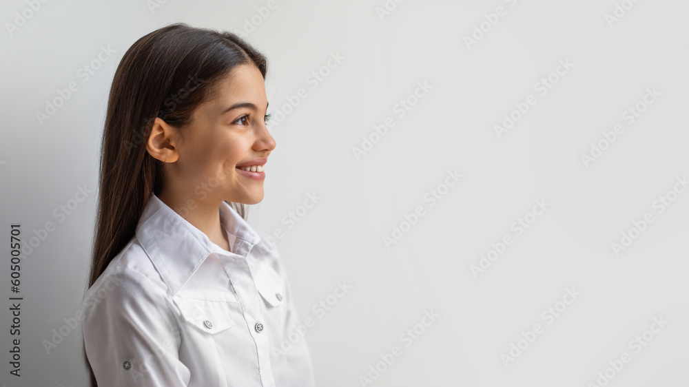 Side View Of Happy Middle Eastern Girl Against White Wall Side View Of Happy Middle Eastern Girl Against White Wall