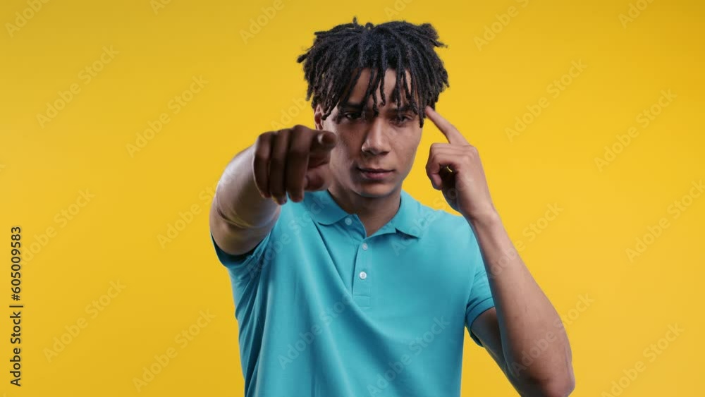 African clever man with gesture - you, think about it. Looking camera on yellow