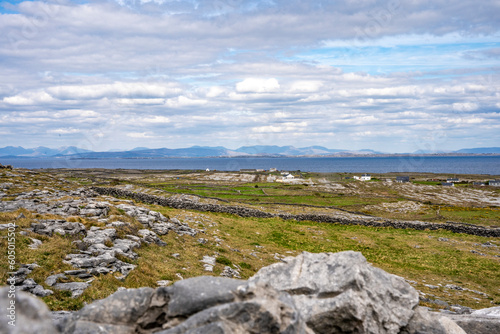 Landscape of Inis Mór, or Inishmore, the largest of the Aran Islands in Galway Bay, off the west coast of Ireland, with houses and stone walls.