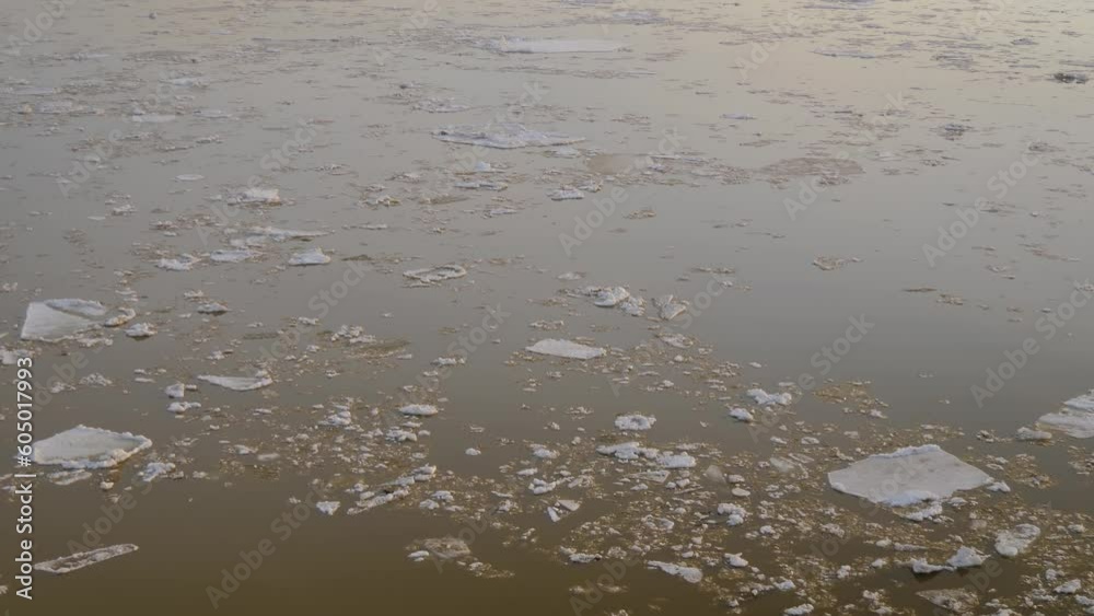 Ice drifting on the Volga river in spring - ice floes floating on water in April. Abstract, springtime, seasonal and environment conept Ice drifting on the Volga river in spring - ice floes floating on water in April. Abstract, springtime, seasonal and environment conept