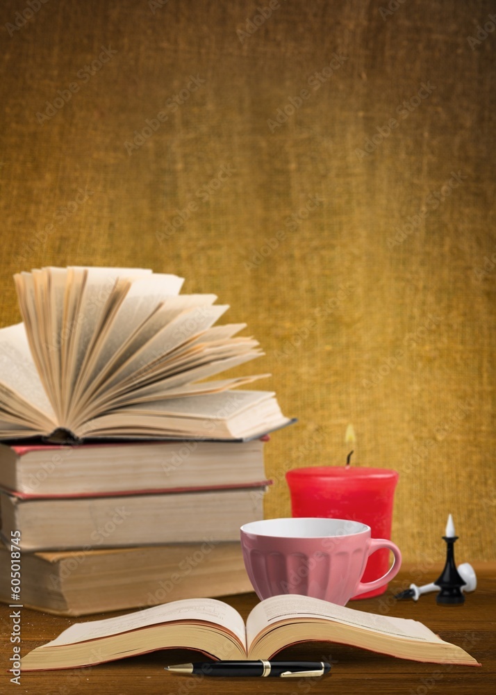 Naklejka premium Stack of old vintage books and cup of tea