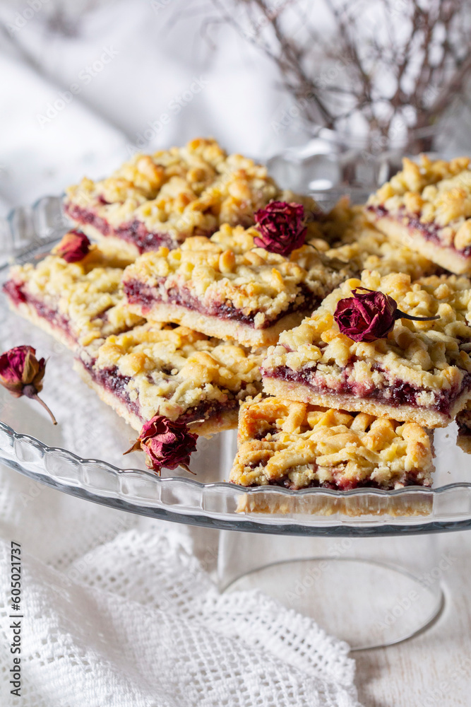 Streusel pie with currant and rose petal filling on a light background.