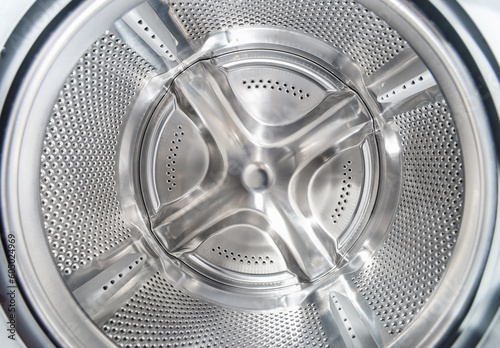 Inside of washing machine. Rotating inner tub. Material metal. Close-up of electrical household appliance.