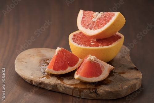 Sliced grapefruit on wood board closeup