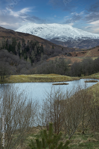 Loch Ranghoch Pitlochry Scotland. Lake and snowcapped mountains.
