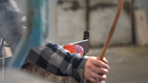Craftsman Shaping a Ball of Molten Glass. Close Up.