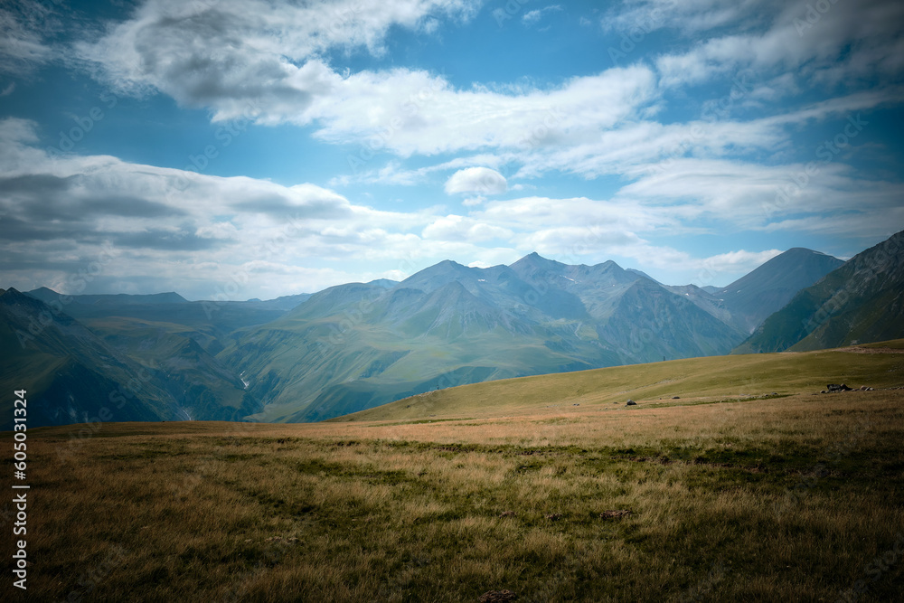 Mountain ranges on a sunny day at Georgia. Sky with clouds adn hills Mountain ranges on a sunny day at Georgia. Sky with clouds adn hills