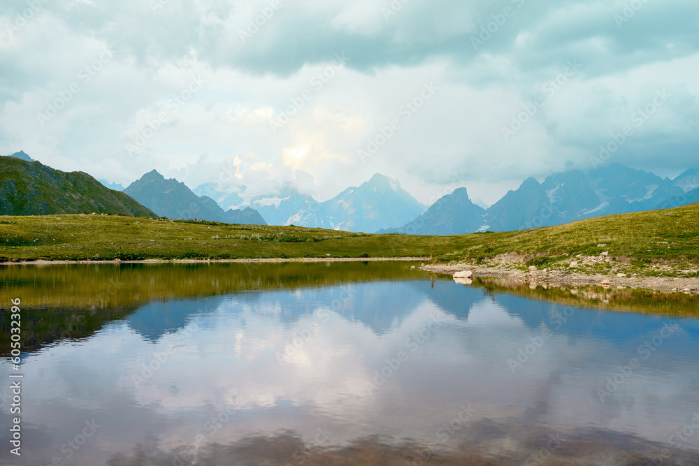 Lake in the mountains on a sunny day in Georgia. Reservoir on the river in the mountains