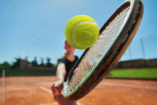 Before her training, the tennis player joyfully playing with a tennis ball, radiating enthusiasm and playfulness, as she prepares herself mentally and physically for the upcoming challenges on the © .shock