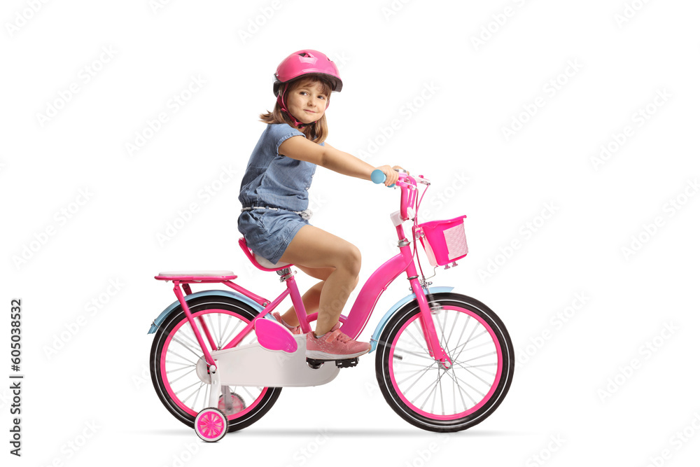 Naklejka premium Girl riding a bicycle with a helmet and looking at camera