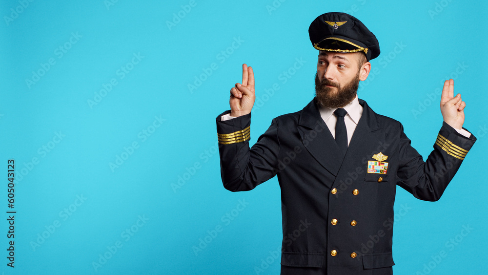 Caucasian male pilot doing landing signals for airplanes, helping other aviators to land and arrive on ground. Airline captain showing air signs with hands on camera, professional occupation. Caucasian male pilot doing landing signals for airplanes, helping other aviators to land and arrive on ground. Airline captain showing air signs with hands on camera, professional occupation.