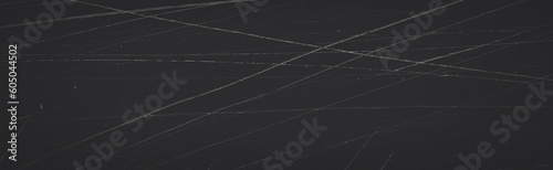 Dark wide panoramic background. Scratched film texture. Lots of scratched lines in different directions and grain on a black background. Faded retro texture. Blank vintage background for grunge design photo