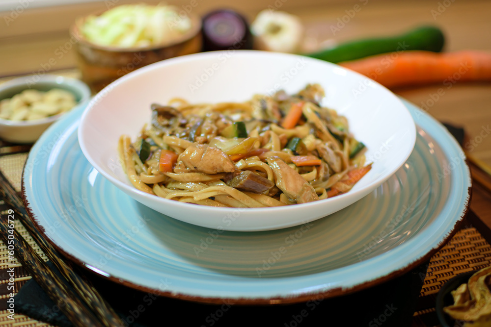 Rice noodles served with vegetables and meat in white bowl. Rice noodles served with vegetables and meat in white bowl.