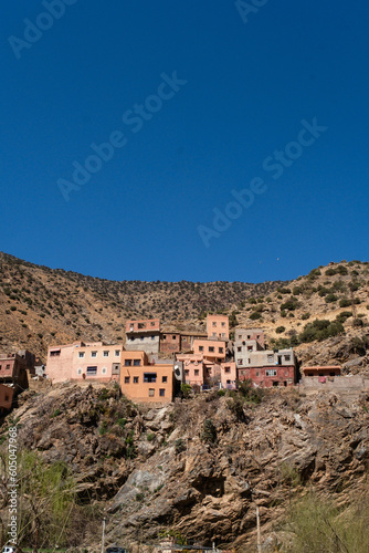 A town sits on the skirts of the mountains of the Ourika Valley in the High Atlas of Morocco