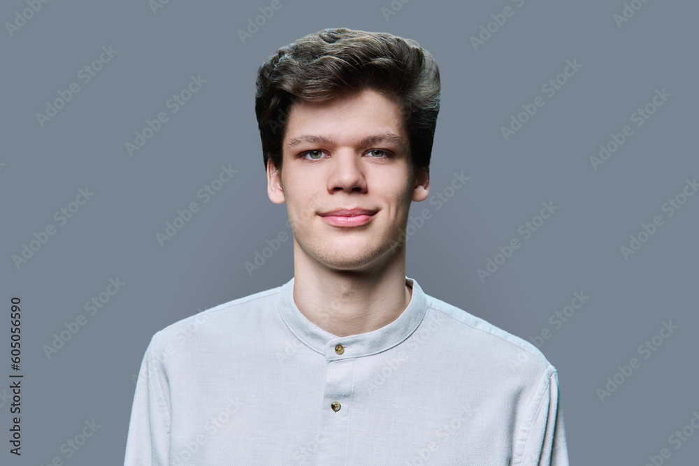 Headshot portrait of young male on gray background Headshot portrait of young male on gray background