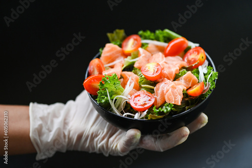 fresh raw salmon fish cooking food seafood salmon fish healthy food on hand, salmon salad food salmon fillet with vegetable lettuce leaf tomato herb and spices