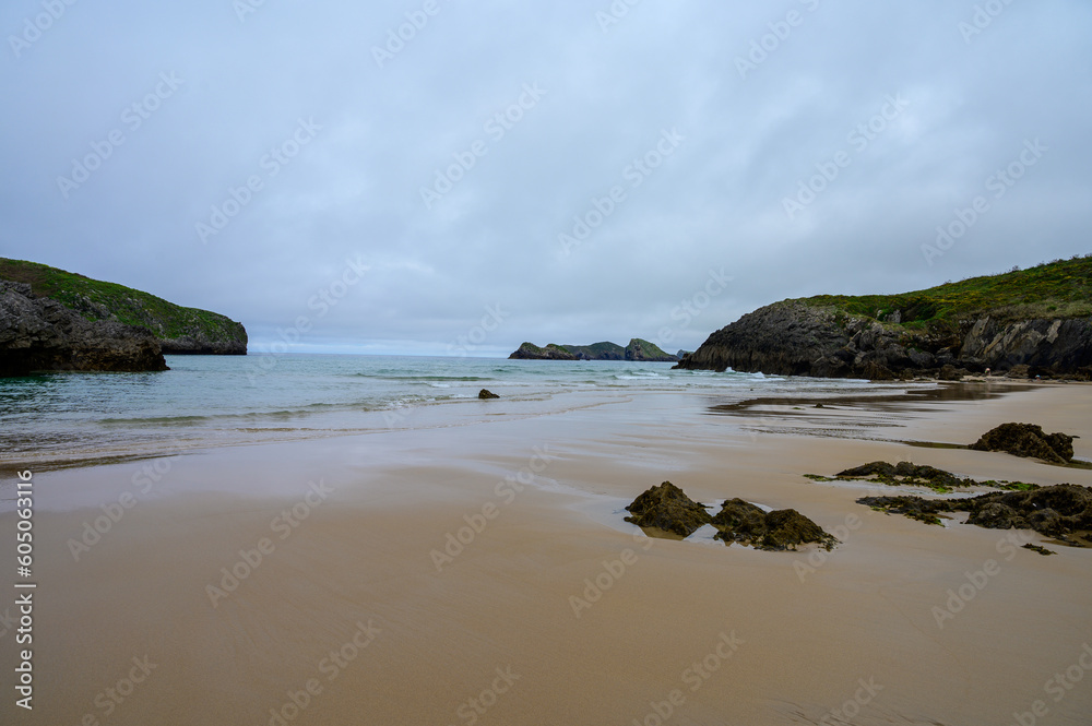 View on Playa de Borizo in Celorio, Green coast of Asturias, North Spain with sandy beaches, cliffs, hidden caves, green fields and mountains. View on Playa de Borizo in Celorio, Green coast of Asturias, North Spain with sandy beaches, cliffs, hidden caves, green fields and mountains.