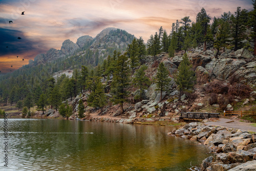 Horizontal, color image of Lily Lake in Colorado, under a dramtic sky.