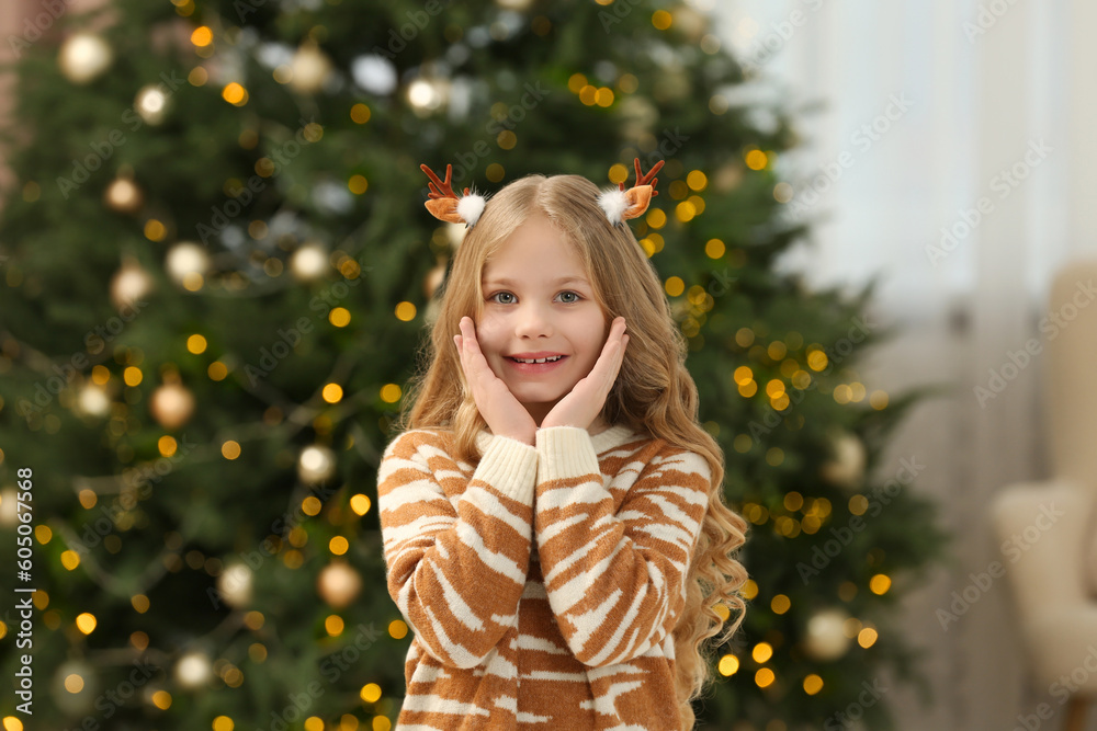 Portrait of cute girl wearing Christmas hair clips at home Portrait of cute girl wearing Christmas hair clips at home