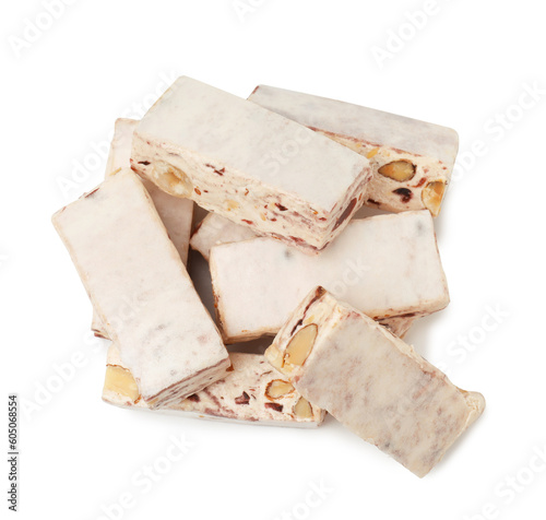 Many pieces of delicious nougat on white background, top view photo