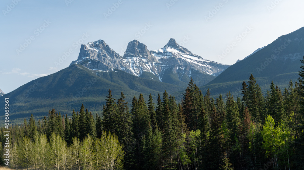 Beautiful view of Three sisters peaks near Canmore Canada with green trees Beautiful view of Three sisters peaks near Canmore Canada with green trees