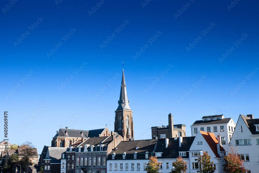Panorama of the Maastricht Waterfront on the Meuse Maas river with a focus on the Sint Martniuskerk, a catholic church, and the ridder brewery in maastricht, Netherlands.