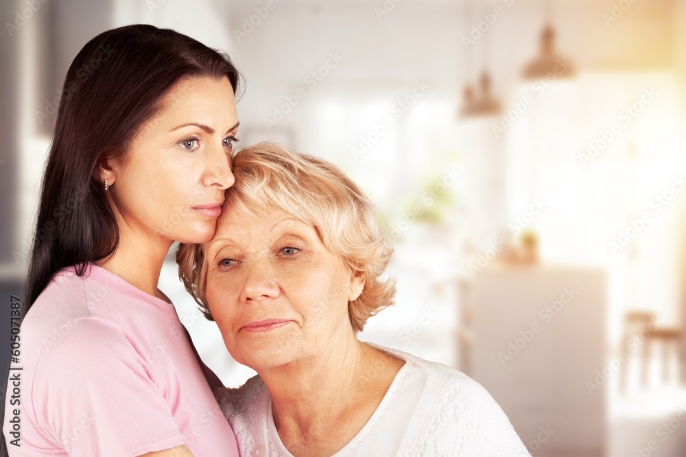 A young daughter with old mother hugging