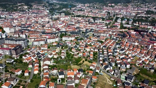 Aerial tilt down reveals neighborhod homes of ourense, galicia, spain photo