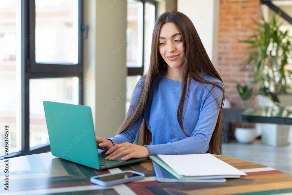 smiling and looking with a happy confident expression. laptop and desk concept smiling and looking with a happy confident expression. laptop and desk concept