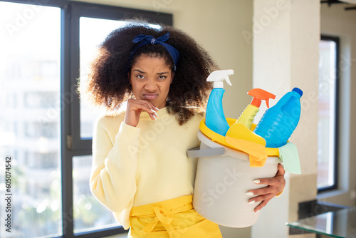 pretty afro black woman with mouth and eyes wide open and hand on chin. housekeeper cleaner concept