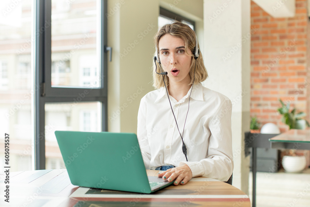 pretty woman feeling extremely shocked and surprised. telemarketer concept pretty woman feeling extremely shocked and surprised. telemarketer concept