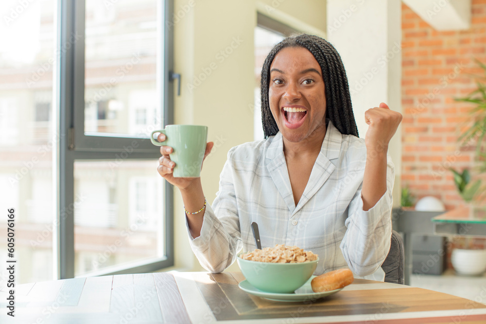 black afro woman feeling shocked,laughing and celebrating success. breakfast concept black afro woman feeling shocked,laughing and celebrating success. breakfast concept