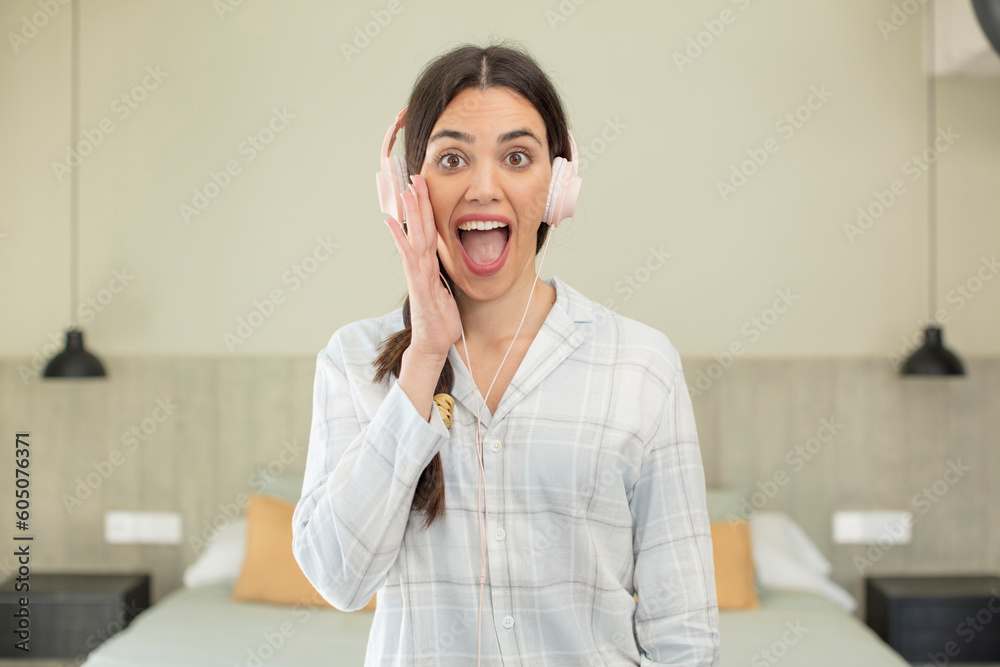 pretty young model feeling happy and astonished at something unbelievable. rest and nightwear concept pretty young model feeling happy and astonished at something unbelievable. rest and nightwear concept