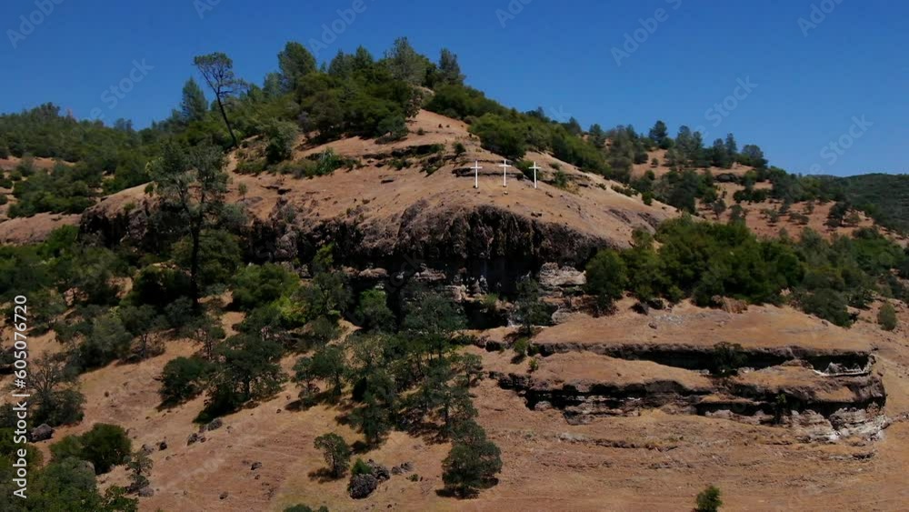 Aerial cinematic drone calvary cross Richard Springs YWAM Chico California Upper Bidwell Park butte cave creek canyon three cross on hillside crucifixion place of skull mid day sunny circling motion Aerial cinematic drone calvary cross Richard Springs YWAM Chico California Upper Bidwell Park butte cave creek canyon three cross on hillside crucifixion place of skull mid day sunny circling motion